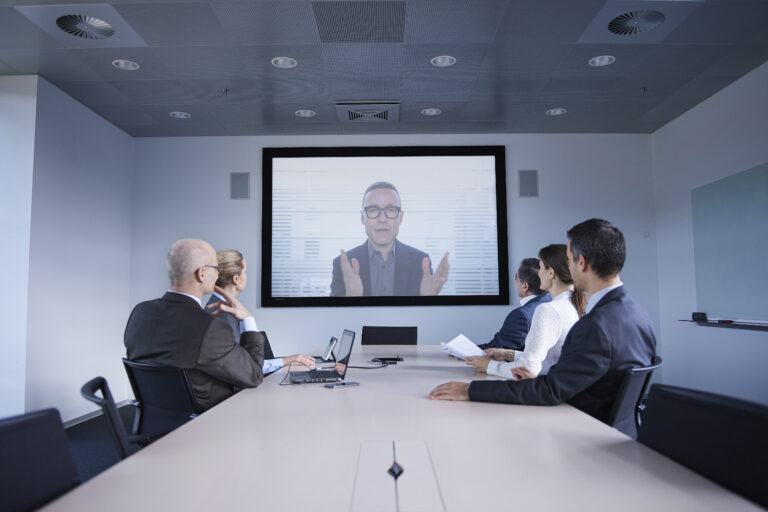 Businessmen and women watching office conference call